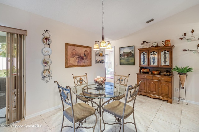 tiled dining space with vaulted ceiling