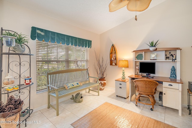 tiled home office with ceiling fan and lofted ceiling