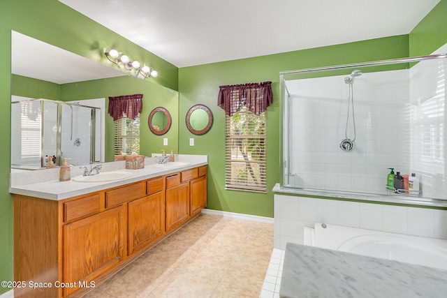 bathroom with a shower with shower door, tile patterned floors, and vanity