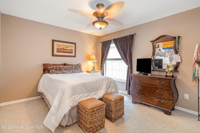 carpeted bedroom with ceiling fan and a textured ceiling