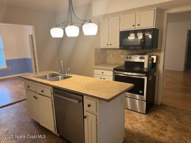 kitchen featuring a kitchen island with sink, sink, white cabinets, pendant lighting, and stainless steel appliances