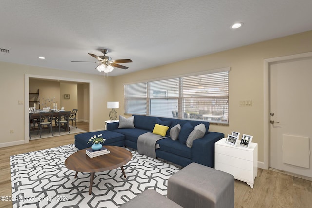 living room featuring recessed lighting, light wood-style flooring, and baseboards