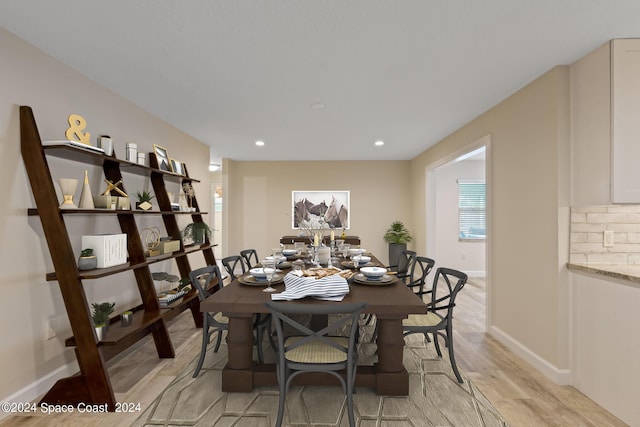 dining space with light wood-type flooring, baseboards, and recessed lighting