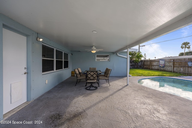 view of pool with a fenced in pool, outdoor dining space, a patio area, and a fenced backyard