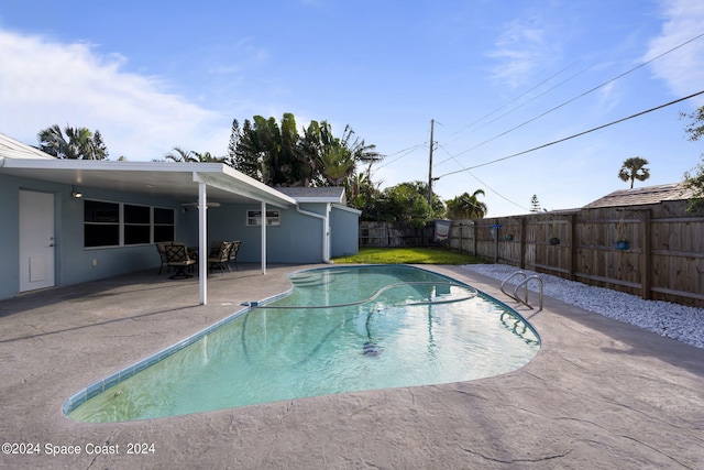 view of swimming pool with a patio area, a fenced backyard, and a fenced in pool