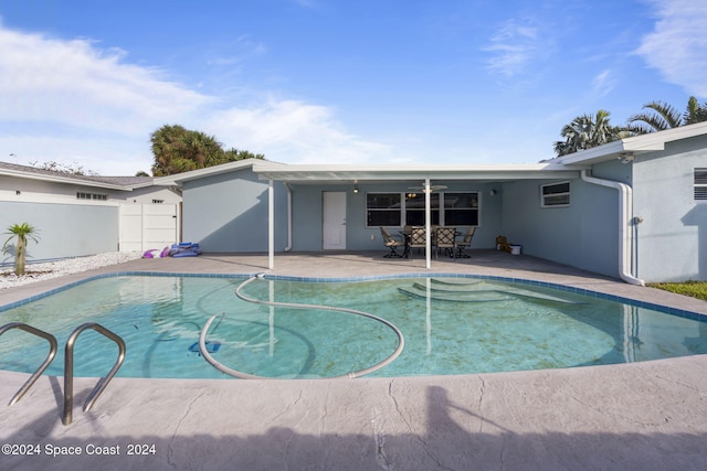 outdoor pool featuring a patio and fence