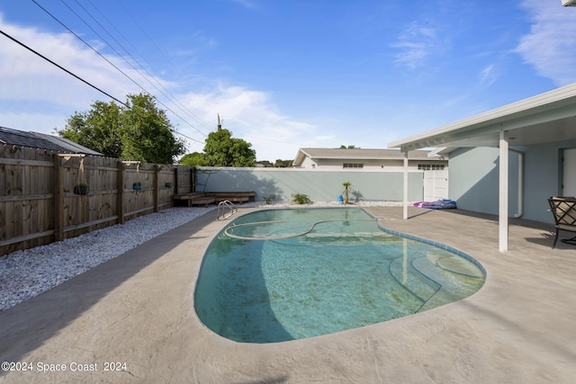 view of swimming pool with a fenced in pool, a fenced backyard, and a patio