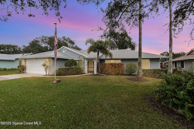 ranch-style home featuring a front lawn, driveway, an attached garage, and stucco siding