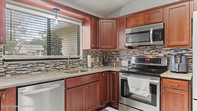 kitchen featuring sink, decorative backsplash, a healthy amount of sunlight, and appliances with stainless steel finishes