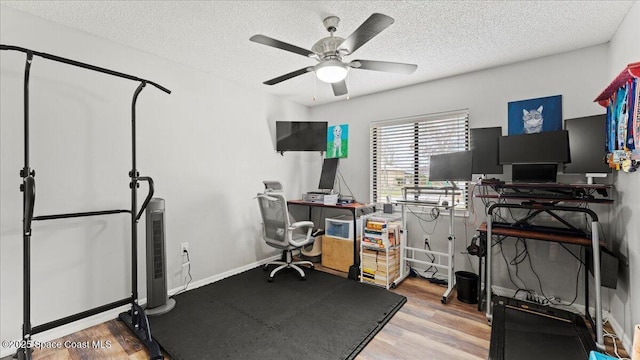 office space with ceiling fan, hardwood / wood-style flooring, and a textured ceiling