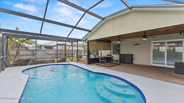 view of pool with ceiling fan, a lanai, and a patio area