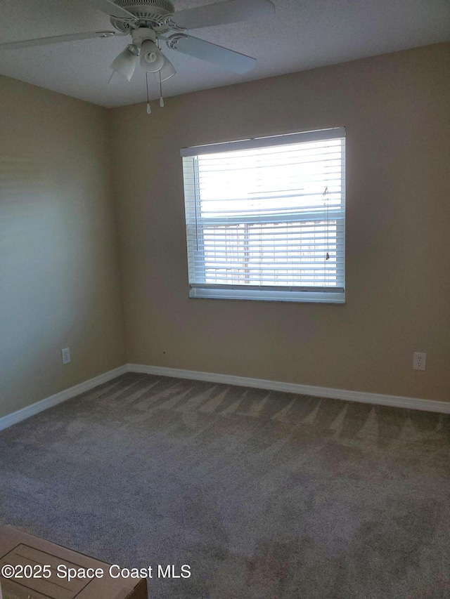 empty room featuring carpet floors and ceiling fan