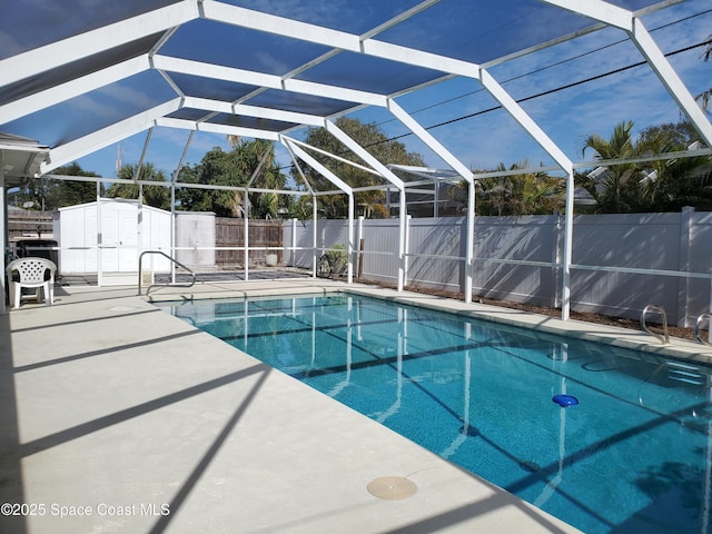 view of swimming pool featuring a storage shed, a lanai, and a patio