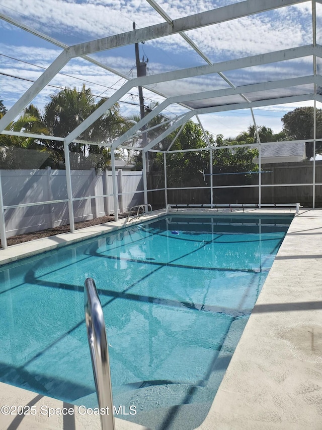 view of swimming pool with glass enclosure