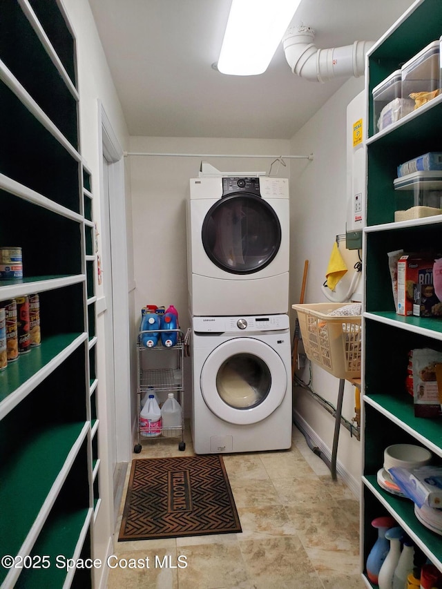 clothes washing area featuring stacked washer / drying machine