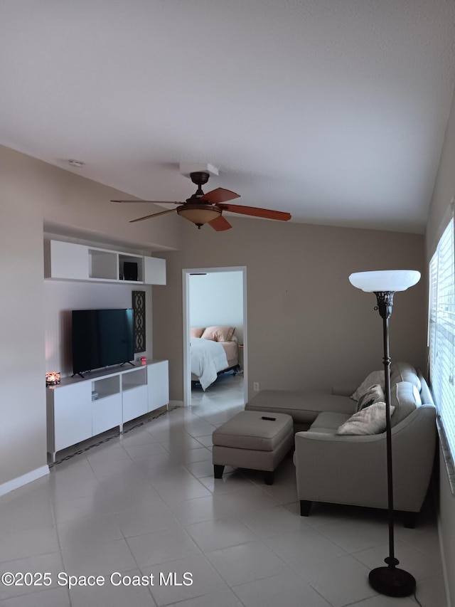 unfurnished living room featuring light tile patterned floors, baseboards, and vaulted ceiling