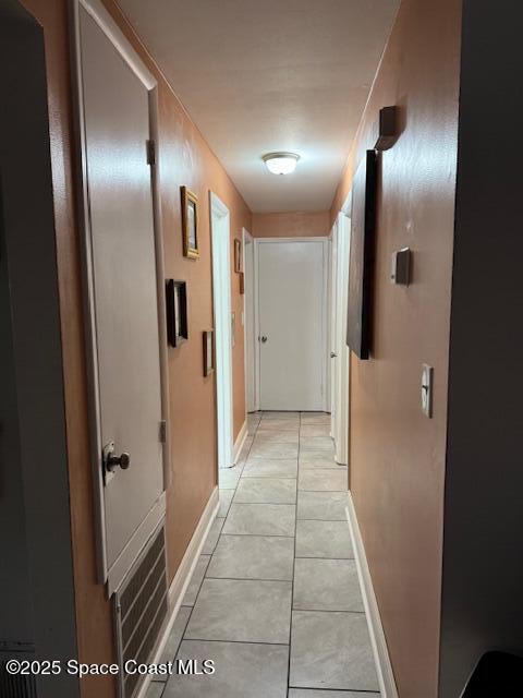 hall featuring light tile patterned floors