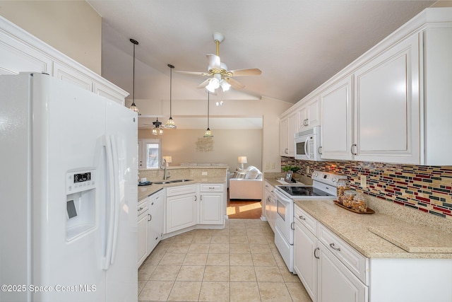 kitchen featuring vaulted ceiling, pendant lighting, sink, white cabinets, and white appliances