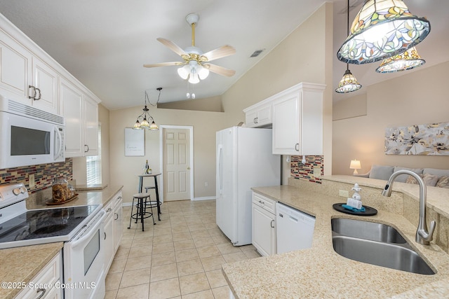 kitchen featuring pendant lighting, sink, white appliances, white cabinetry, and vaulted ceiling