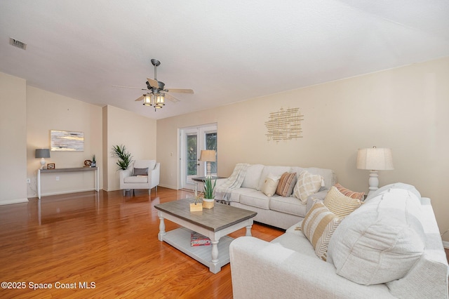 living room featuring ceiling fan and hardwood / wood-style floors