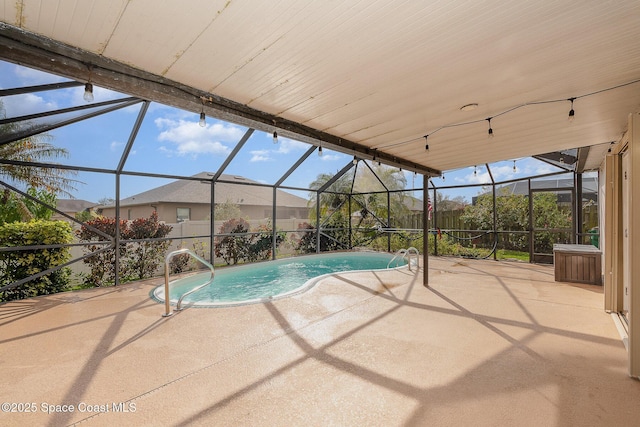 view of swimming pool with glass enclosure and a patio