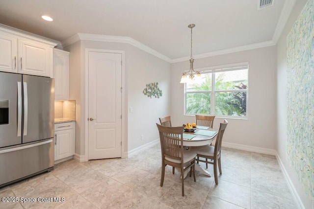 dining room featuring ornamental molding and an inviting chandelier