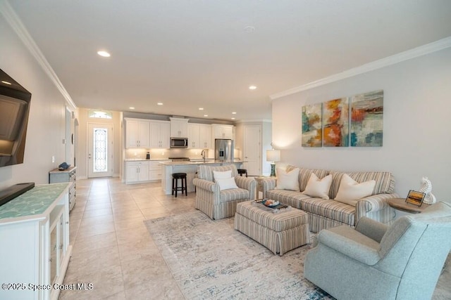 tiled living room with crown molding and sink