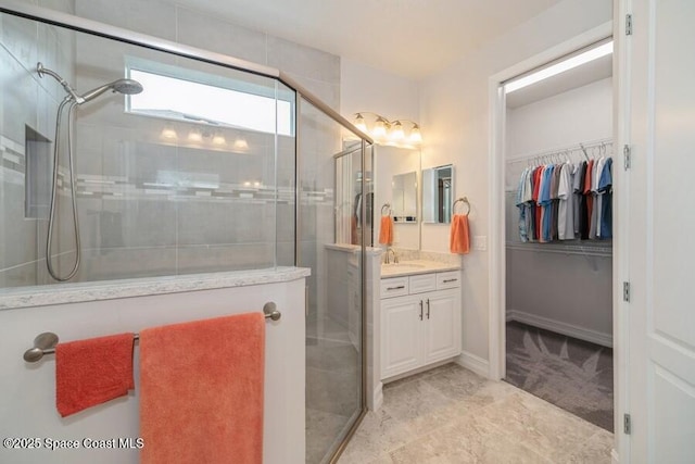 bathroom featuring vanity and a shower with door