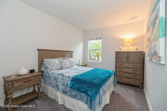 bedroom with dark carpet