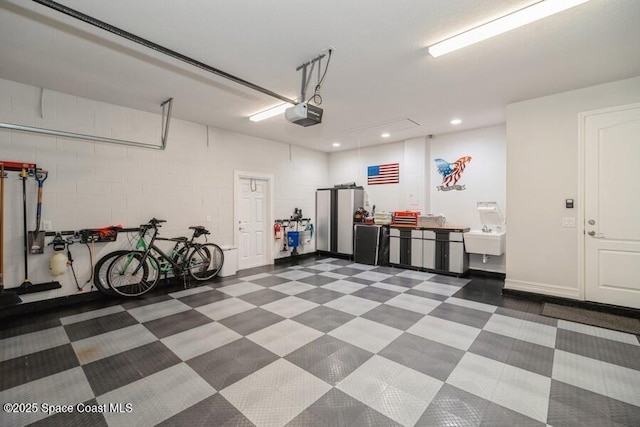 garage featuring a garage door opener and sink