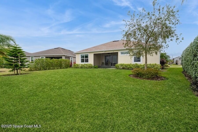 rear view of house with a yard