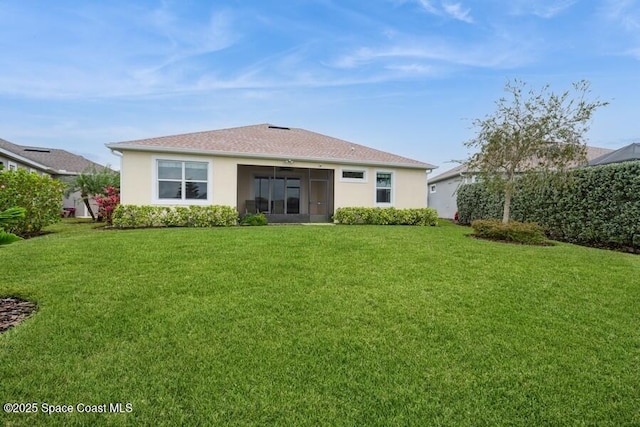 rear view of house featuring a lawn