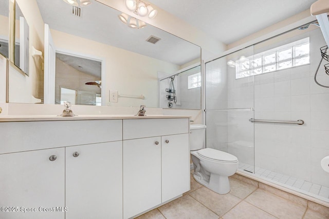 bathroom with vanity, toilet, an enclosed shower, and tile patterned flooring