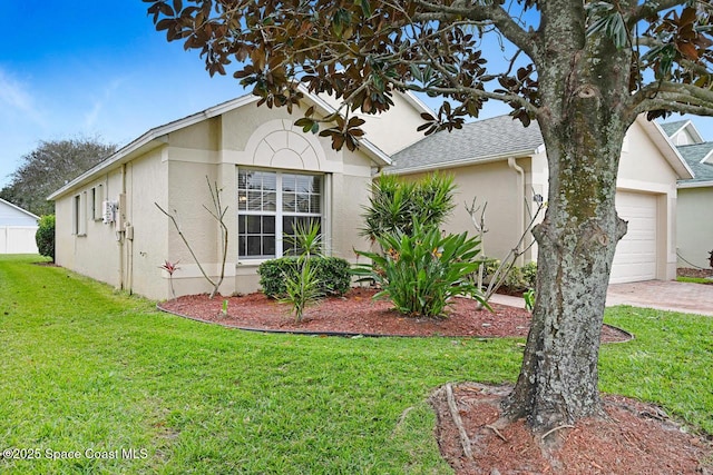 view of property exterior featuring a garage and a yard