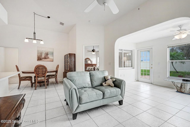 tiled living room with ceiling fan