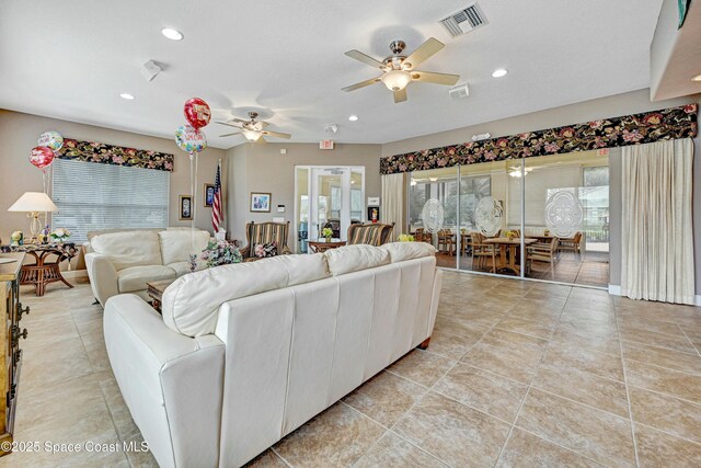 living room with ceiling fan and light tile patterned flooring