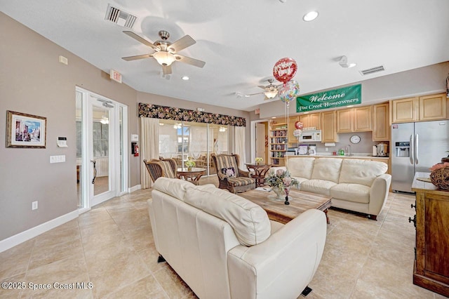 tiled living room featuring ceiling fan and a textured ceiling