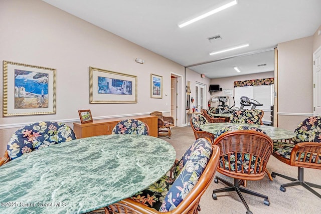 dining area featuring light colored carpet