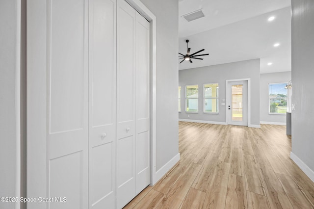 corridor with light hardwood / wood-style flooring