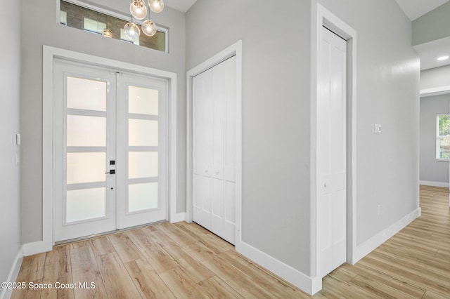 foyer featuring light hardwood / wood-style flooring and french doors