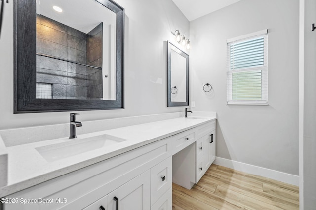 bathroom with hardwood / wood-style floors and vanity