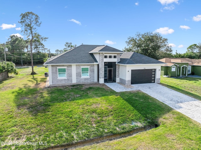 view of front of house featuring a garage and a front yard