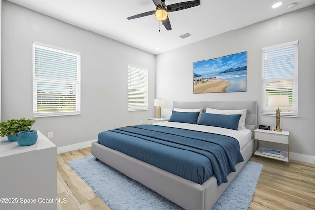 bedroom featuring baseboards, visible vents, light wood finished floors, and recessed lighting