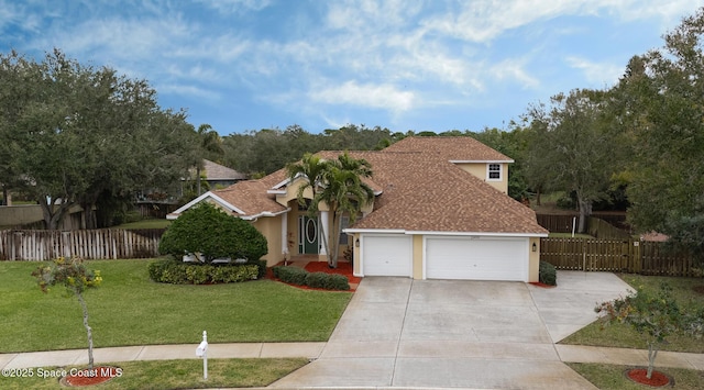 view of front of house featuring a garage and a front yard