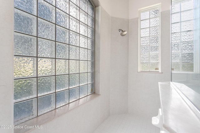 bathroom with a tile shower