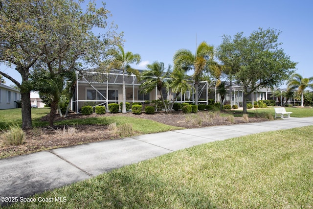 3489 Ahern Pl, Melbourne, FL 32940 - view of front of property with a front yard and a lanai