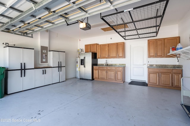 3489 Ahern Pl, Melbourne, FL 32940 - garage featuring electric panel, water heater, a garage door opener, and stainless steel fridge