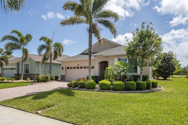 3489 Ahern Pl, Melbourne, FL 32940 - single story home with a front yard, stone siding, a garage, stucco siding, and driveway