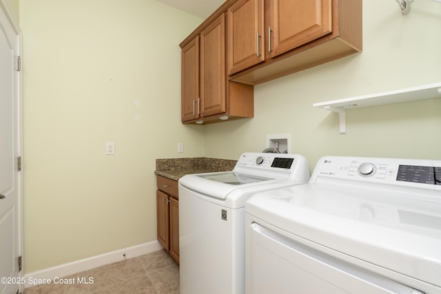 3489 Ahern Pl, Melbourne, FL 32940 - laundry room with light tile patterned floors, baseboards, cabinet space, and washer and clothes dryer