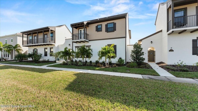 view of front of house featuring a front lawn and stucco siding